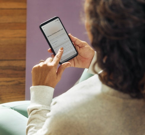 woman-using-a-smartphone-on-a-yoga-mat-.jpg Woman using a smartphone on a yoga mat.